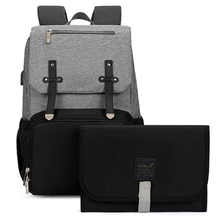 Load image into Gallery viewer, The perfect grey and Black baby diaper backpack. Expertly designed for both style and function, this backpack is an essential tool for any new parent. With a sleek grey and black color scheme, this backpack is perfect for both moms and dads. Stay organized and prepared with its spacious interior and multiple pockets for all your baby&#39;s essentials. Carry it comfortably with its ergonomic design and adjustable straps, making it the perfect accessory for any outing with your little one.
