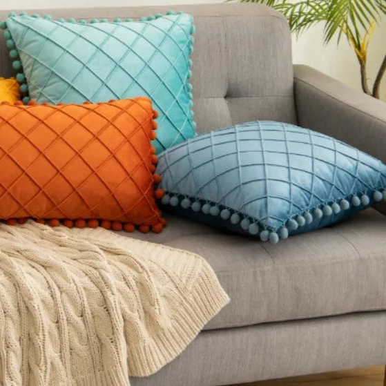 Elevate the look of your children's bedroom or playroom with the unique Stone Blue Pompom Pillow Cover. Designed with faux velvet fabric on both sides, this decorative throw pillow cover offers a plush, comfortable feel. Make a statement with this luxurious accent piece that combines both comfort and style.