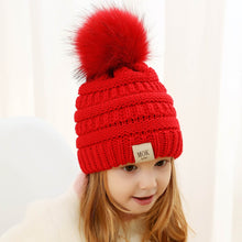 Load image into Gallery viewer, Keep your kid warm with this red beanie hat. Great for children age 1 to 7 years. This knitted cotton hat comes in red, yellow, beige, pink, black, white and grey.
