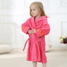 Load image into Gallery viewer, The perfect dinosaur hooded hot pink bathrobe for kids ages 2 to 6 years. This bathrobe comes in blue, green and pink. Material: Cotton. Fabric Type: Worsted.
