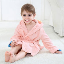 Load image into Gallery viewer, The perfect dinosaur hooded pink bathrobe for kids ages 2 to 6 years. This bathrobe comes in blue, green and pink. Material: Cotton. Fabric Type: Worsted.
