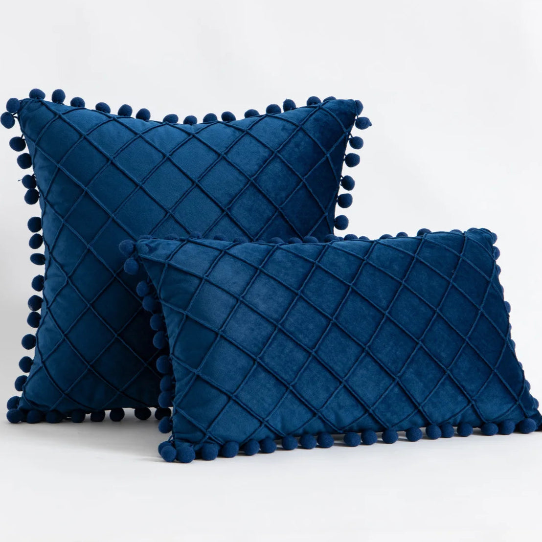 Transform your child's bedroom or playroom into a stylish and modern space with the Dark blue Pompom Pillow Cover. Made from a soft faux velvet material on both sides, this decorative throw pillow cover provides the perfect combination of comfort and luxury. Add a unique touch to any room with this must-have accent piece.