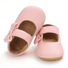 Load image into Gallery viewer, These charming little pink bowknot baby shoes are perfect for babies aged newborn to 18 months old. With a choice of colors, they&#39;ll make a delightful addition to any outfit. A soft soled design ensures maximum comfort, while the bow-tie is sure to put a smile on everyone&#39;s face. Upper Material: PU Leather. Outsole Material: Rubber. Closure Type: Hook &amp; Loop.
