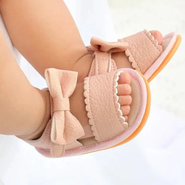 Experience the most adorable and stylish bow sandals for your little one, suitable for newborns to 18 months old. These sandals boast anti-slip protection, a comfortable flat sole, and lightweight design for your baby's safety and comfort.