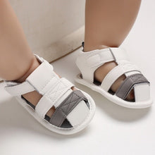 Load image into Gallery viewer, These adorable Summer white and grey sandals are designed to keep your little one&#39;s feet cool in the hot summer months! They come in multiple colors and sizes for newborns up to 18 months, so you&#39;ll be sure to find a pair for all your little one&#39;s summer adventures. Cute and comfy - it&#39;s a win-win! Upper Material: PU Leather. Outsole Material: Cotton. Heel Type: Flat.
