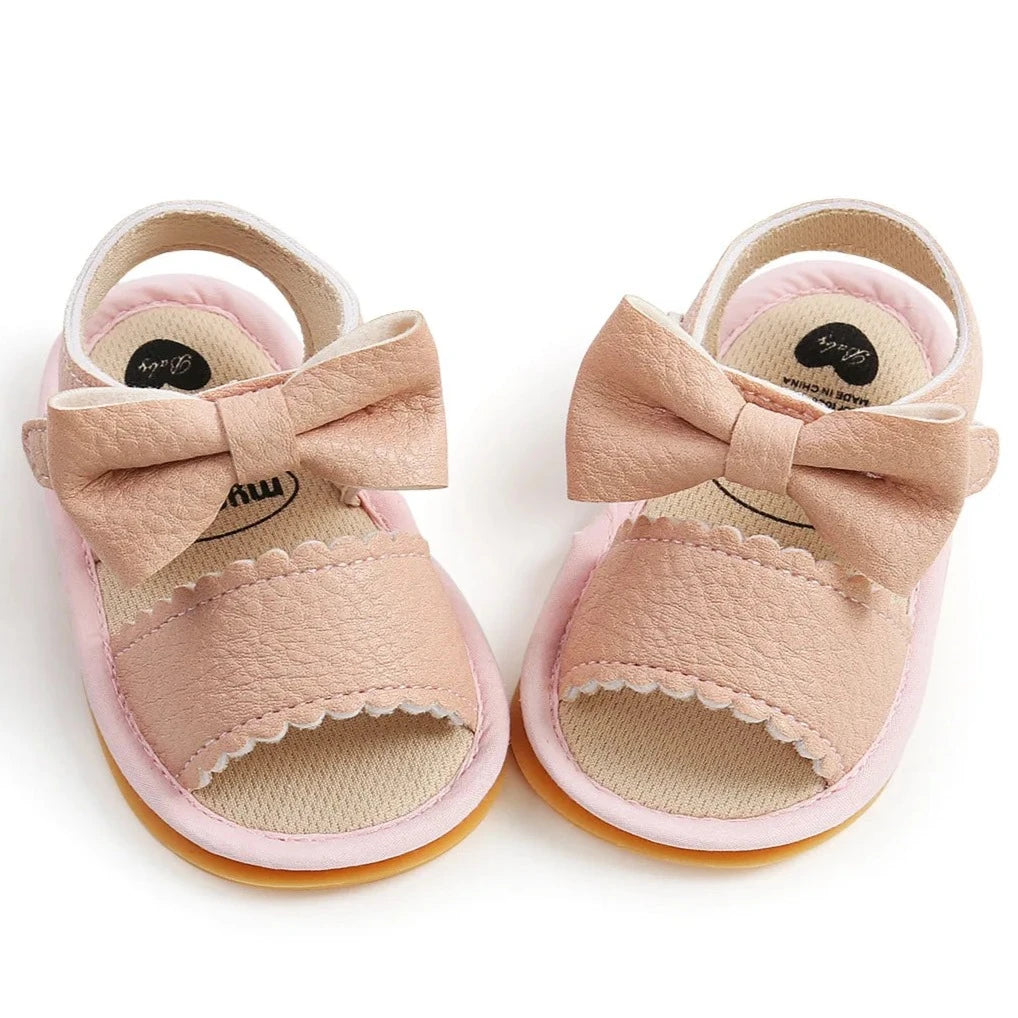 Experience the most adorable and stylish bow sandals for your little one, suitable for newborns to 18 months old. These sandals boast anti-slip protection, a comfortable flat sole, and lightweight design for your baby's safety and comfort.