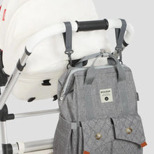 Load image into Gallery viewer, Crafted for both style and convenience, the Light Grey Diaper Backpack is the perfect travel companion for parents on-the-go. Equipped with stroller straps, this fashion-forward backpack is a must-have for any trendy parent.
