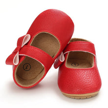 Load image into Gallery viewer, These charming little red bowknot baby shoes are perfect for babies aged newborn to 18 months old. With a choice of colors, they&#39;ll make a delightful addition to any outfit. A soft soled design ensures maximum comfort, while the bow-tie is sure to put a smile on everyone&#39;s face. Upper Material: PU Leather. Outsole Material: Rubber. Closure Type: Hook &amp; Loop.
