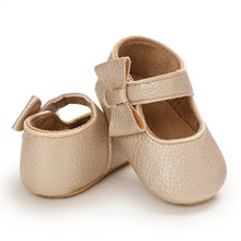 Load image into Gallery viewer, These charming little gold bowknot baby shoes are perfect for babies aged newborn to 18 months old. With a choice of colors, they&#39;ll make a delightful addition to any outfit. A soft soled design ensures maximum comfort, while the bow-tie is sure to put a smile on everyone&#39;s face. Upper Material: PU Leather. Outsole Material: Rubber. Closure Type: Hook &amp; Loop.
