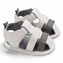 Load image into Gallery viewer, These adorable Summer white and grey sandals are designed to keep your little one&#39;s feet cool in the hot summer months! They come in multiple colors and sizes for newborns up to 18 months, so you&#39;ll be sure to find a pair for all your little one&#39;s summer adventures. Cute and comfy - it&#39;s a win-win! Upper Material: PU Leather. Outsole Material: Cotton. Heel Type: Flat.
