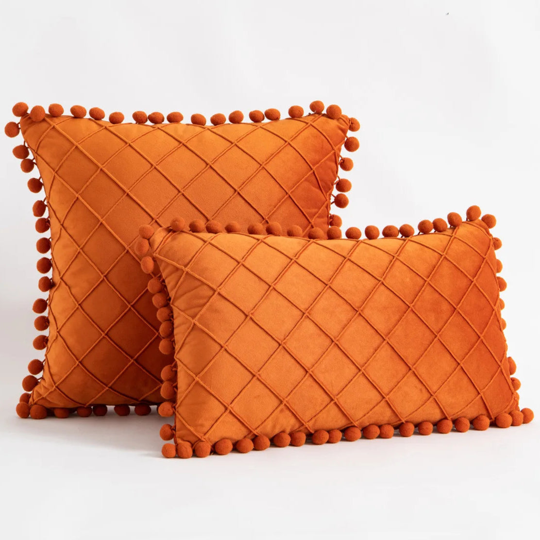 Refresh and add a modern touch to your child's bedroom or playroom with this Orange Pompom Pillow Cover. Made from soft faux velvet on both sides, this decorative throw pillow offers the perfect balance of comfort and style. Elevate any space with this unique and luxurious accent piece.