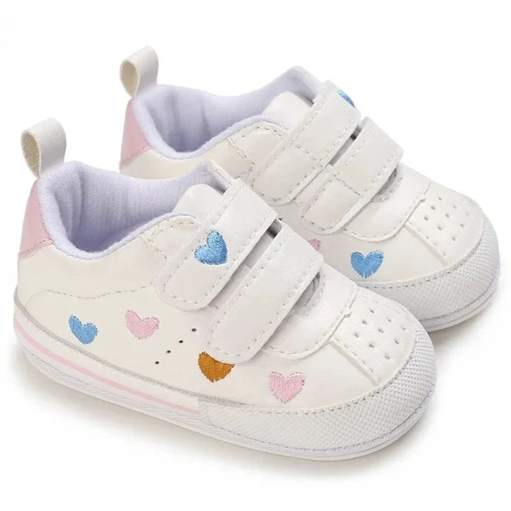 Experience the ultimate in comfort and style with our white embroidered hearts baby sneakers! Adorned with colorful hearts, these sneakers are perfect for babies aged newborn to 18 months. Stay comfortable and steady on your feet with their breathable and non-slip design.