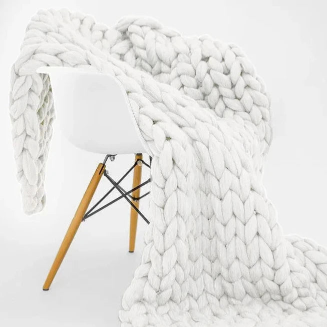 Experience the ultimate comfort with our luxurious hand-knitted Nordic blanket in classic white. Perfect for your child's bedroom, its thick texture provides warmth and coziness, while the high-quality material allows for excellent breathability and color retention. Upgrade your child's room today with this must-have addition!