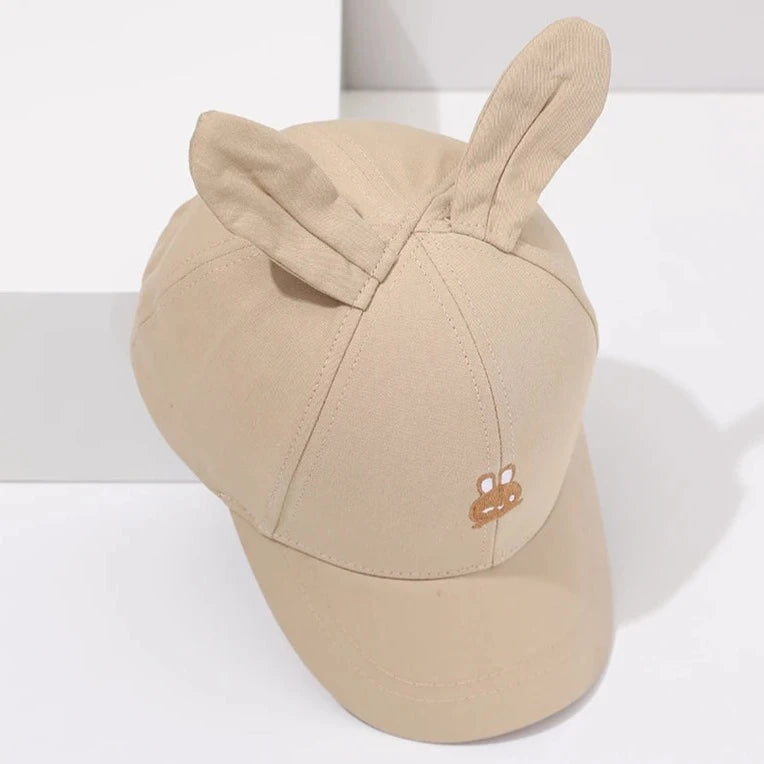 Introducing the adorable Bunny Ears Baseball Hat, available in pink, black, white, and khaki for children newborn to 3 years old! Perfect for adding a touch of cuteness to any outfit.