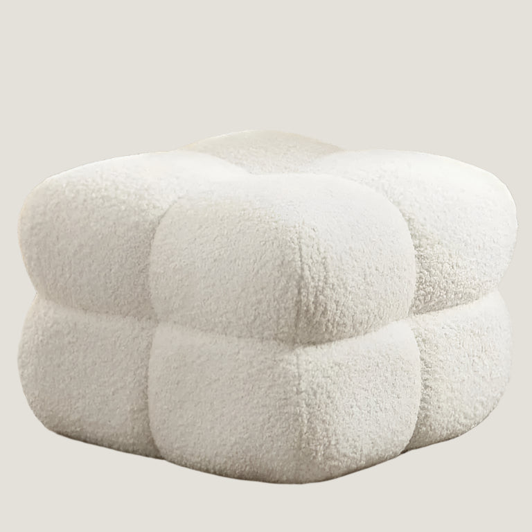 This cloud ottoman boasts an elegant but daring design, upholstered in chic Nepal sherpa fabric. Its bold textured tufting and divided, equant cubed sections on each side add both visual and functional drama.