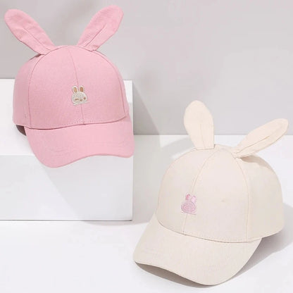 Introducing the adorable Bunny Ears Baseball Hat, available in pink, black, white, and khaki for children newborn to 3 years old! Perfect for adding a touch of cuteness to any outfit.