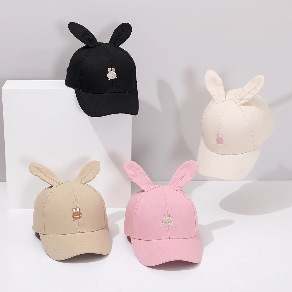 Introducing the adorable Bunny Ears Baseball Hat, available in pink, black, white, and khaki for children newborn to 3 years old! Perfect for adding a touch of cuteness to any outfit.