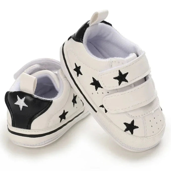 Elevate your little one's style with our Sporty Star Sneakers, designed for newborns to 18 months. These breathable, non-slip shoes feature a crisp white color and sleek black stars, perfect for budding athletes.