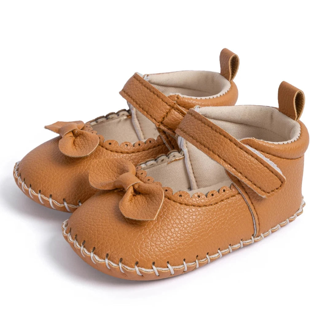 Designed with both style and comfort in mind, these Little Bow-Tie baby shoes are available in a variety of colors and sizes for newborns up to 18 months old. Each pair is meticulously crafted to provide a snug and secure fit for your little princess. Whether you're dressing them up for a special occasion or keeping them comfy for everyday wear, these shoes are the perfect choice for your little one.