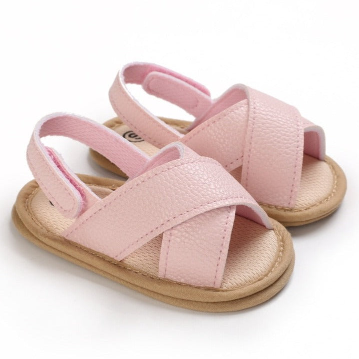A perfect fit for your little one's feet, our pink white Malta Sandals come in white, brown and black and fit babies and tots from newborn to 18 months. Comfortable and stylish, they'll be walking in style. Upper Material: PU Leather. Outsole Material: Rubber and Cotton. Heel Type: Flat.