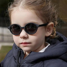 Load image into Gallery viewer, Experience the ultimate in sun protection for your little ones with our Ultra-light Baby and Toddler Sunglasses! These polarized, anti-UV shades are perfect for children ages 0-3 years. Keep your child&#39;s delicate eyes safe from harmful rays in retro round frames that are flexible and lightweight. Choose from multiple colors to fit your child&#39;s unique style. Trust us, these sunglasses are a must-have for any parent who values their child&#39;s well-being. Order now and see the difference they make!
