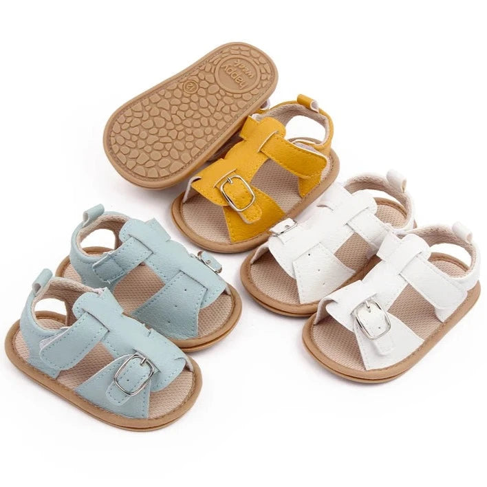 Bring comfort and style to your little one's summer with these adorable sandals in vibrant yellow, crisp white, and cool blue. Perfect for newborns to 18-month-olds, these sandals will have your baby looking cute from every angle. Elevate your baby's style with these adorable and versatile sandals! Keep your little one's feet cool and comfortable all summer long with these must-have sandals