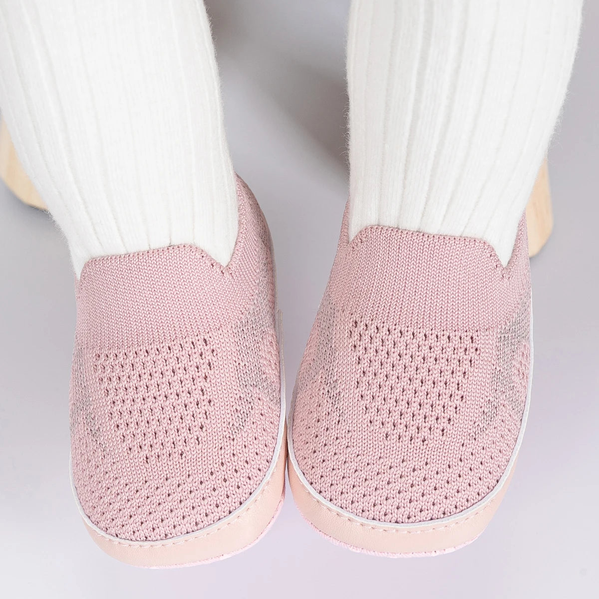 Easily breathable and featherlight infant shoes in shades of pink, white, and grey; perfect for newborns up to 18 months of age.