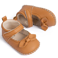 Load image into Gallery viewer, Designed with both style and comfort in mind, these Little Bow-Tie baby shoes are available in a variety of colors and sizes for newborns up to 18 months old. Each pair is meticulously crafted to provide a snug and secure fit for your little princess. Whether you&#39;re dressing them up for a special occasion or keeping them comfy for everyday wear, these shoes are the perfect choice for your little one.
