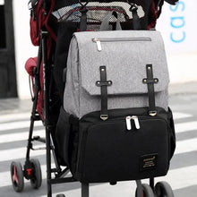 Load image into Gallery viewer, The perfect grey and Black baby diaper backpack. Expertly designed for both style and function, this backpack is an essential tool for any new parent. With a sleek grey and black color scheme, this backpack is perfect for both moms and dads. Stay organized and prepared with its spacious interior and multiple pockets for all your baby&#39;s essentials. Carry it comfortably with its ergonomic design and adjustable straps, making it the perfect accessory for any outing with your little one.
