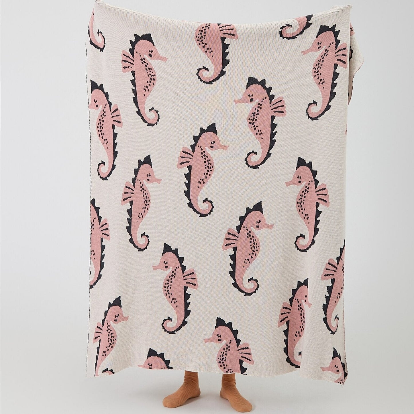 Snuggle up with an ocean of comfort! Our knitted sea horse cotton blanket is perfect for your little mermaid or sailor's bedroom or nursery. It's made of Grade A, 100% cotton with a yarn dyed pattern and comes in two cute colors: blue and pink. Yo-ho-ho and a pirate's hug! Size: 51.18 x 62.99 inches (130cm x 160cm).