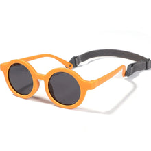 Load image into Gallery viewer, Indulge your little one&#39;s eyes with the ultimate protection and style of these polarized baby and toddler sunglasses! Perfect for ages 0-36 months, these round shades come with a flexible strap for added security and comfort. Whether your child is a newborn or an energetic toddler, these sunglasses are sure to keep their eyes safe and stylish!
