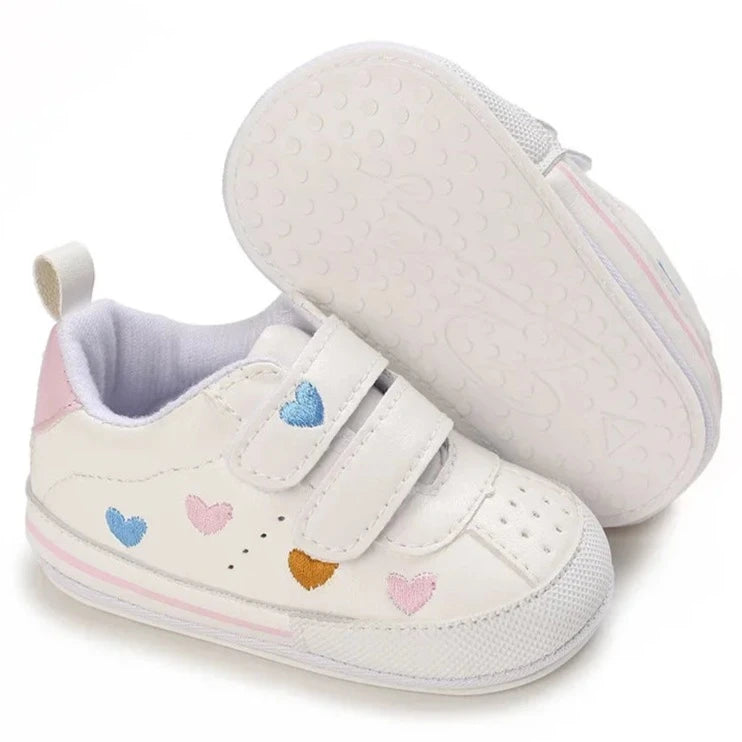 Experience the ultimate in comfort and style with our white embroidered hearts baby sneakers! Adorned with colorful hearts, these sneakers are perfect for babies aged newborn to 18 months. Stay comfortable and steady on your feet with their breathable and non-slip design.