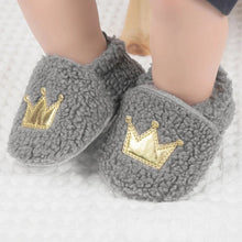 Load image into Gallery viewer, These cozy, snuggly slippers are fit for a royal baby! Made with fluffy teddy bear fabric to keep little toes warm and toasty. Available in sizes for newborns up to 18 months old. Choose from white, grey, or brown.
