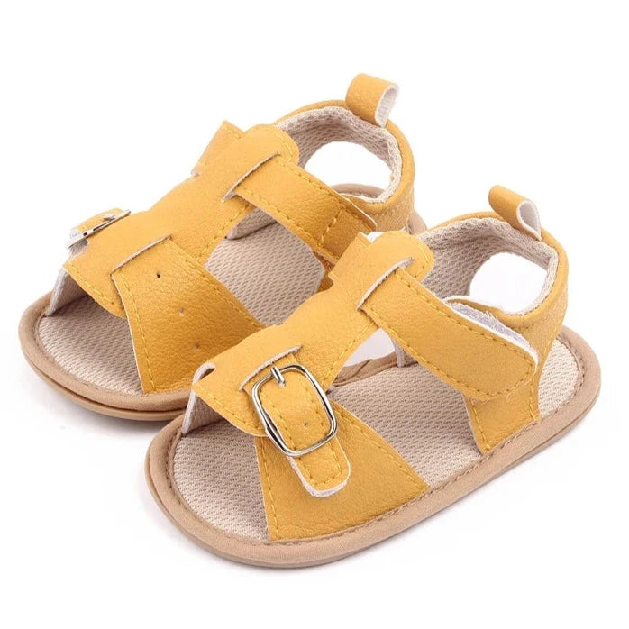 Bring comfort and style to your little one's summer with these adorable sandals in vibrant yellow, crisp white, and cool blue. Perfect for newborns to 18-month-olds, these sandals will have your baby looking cute from every angle. Elevate your baby's style with these adorable and versatile sandals! Keep your little one's feet cool and comfortable all summer long with these must-have sandals