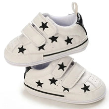 Load image into Gallery viewer, Elevate your little one&#39;s style with our Sporty Star Sneakers, designed for newborns to 18 months. These breathable, non-slip shoes feature a crisp white color and sleek black stars, perfect for budding athletes.
