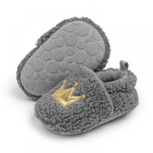 Load image into Gallery viewer, These cozy, snuggly slippers are fit for a royal baby! Made with fluffy teddy bear fabric to keep little toes warm and toasty. Available in sizes for newborns up to 18 months old. Choose from white, grey, or brown.
