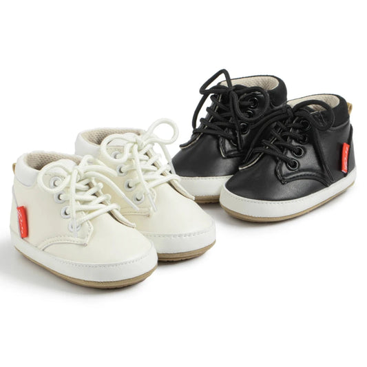 Crafted with the utmost care, these premium leather baby sneakers come in black and beige for a versatile and stylish look. Perfect for your little one's active lifestyle.