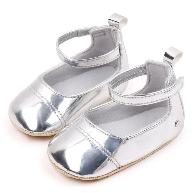 The perfect first time walker shoes for your little walker. Shower your little one's feet with style and comfort with our Bling Baby Shoes | Multiple Colors! Designed for newborns to 18 months, these shoes are perfect for your child's first steps. Supportive and durable, they'll keep your little walker's feet protected as they explore the world. Give them the confidence to take those first steps with our Bling Baby Shoes