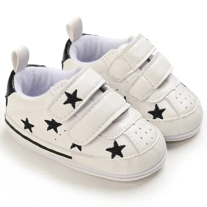 Elevate your little one's style with our Sporty Star Sneakers, designed for newborns to 18 months. These breathable, non-slip shoes feature a crisp white color and sleek black stars, perfect for budding athletes.