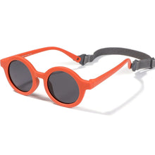 Load image into Gallery viewer, Indulge your little one&#39;s eyes with the ultimate protection and style of these polarized baby and toddler sunglasses! Perfect for ages 0-36 months, these round shades come with a flexible strap for added security and comfort. Whether your child is a newborn or an energetic toddler, these sunglasses are sure to keep their eyes safe and stylish!
