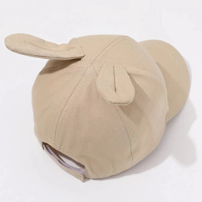 Introducing the adorable Bunny Ears Baseball Hat, available in pink, black, white, and khaki for children newborn to 3 years old! Perfect for adding a touch of cuteness to any outfit.