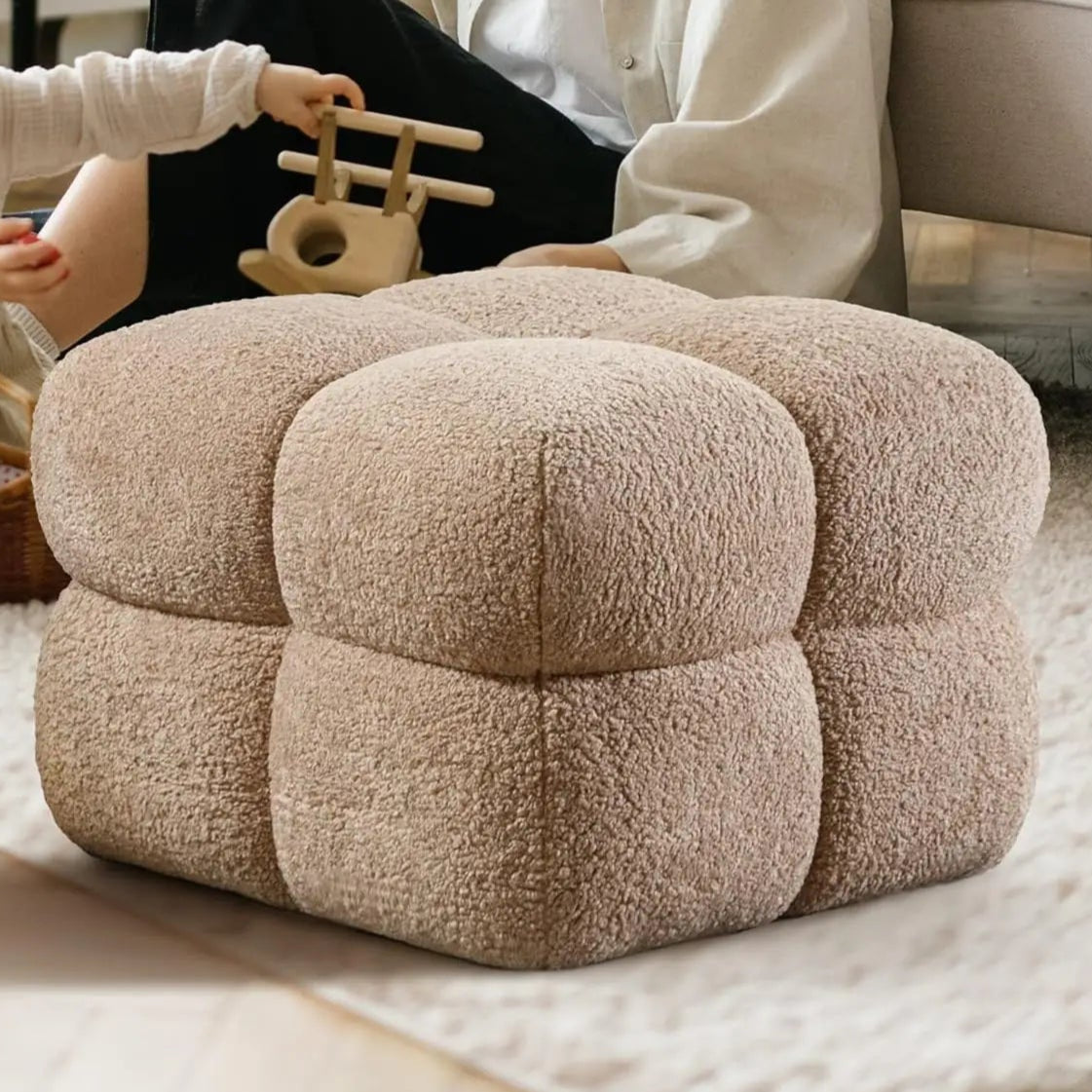 This cloud ottoman boasts an elegant but daring design, upholstered in chic Nepal sherpa fabric. Its bold textured tufting and divided, equant cubed sections on each side add both visual and functional drama.