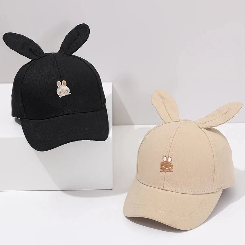 Introducing the adorable Bunny Ears Baseball Hat, available in pink, black, white, and khaki for children newborn to 3 years old! Perfect for adding a touch of cuteness to any outfit.