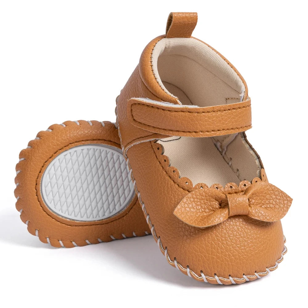 Designed with both style and comfort in mind, these Little Bow-Tie baby shoes are available in a variety of colors and sizes for newborns up to 18 months old. Each pair is meticulously crafted to provide a snug and secure fit for your little princess. Whether you're dressing them up for a special occasion or keeping them comfy for everyday wear, these shoes are the perfect choice for your little one.