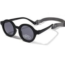 Load image into Gallery viewer, Indulge your little one&#39;s eyes with the ultimate protection and style of these polarized baby and toddler sunglasses! Perfect for ages 0-36 months, these round shades come with a flexible strap for added security and comfort. Whether your child is a newborn or an energetic toddler, these sunglasses are sure to keep their eyes safe and stylish!
