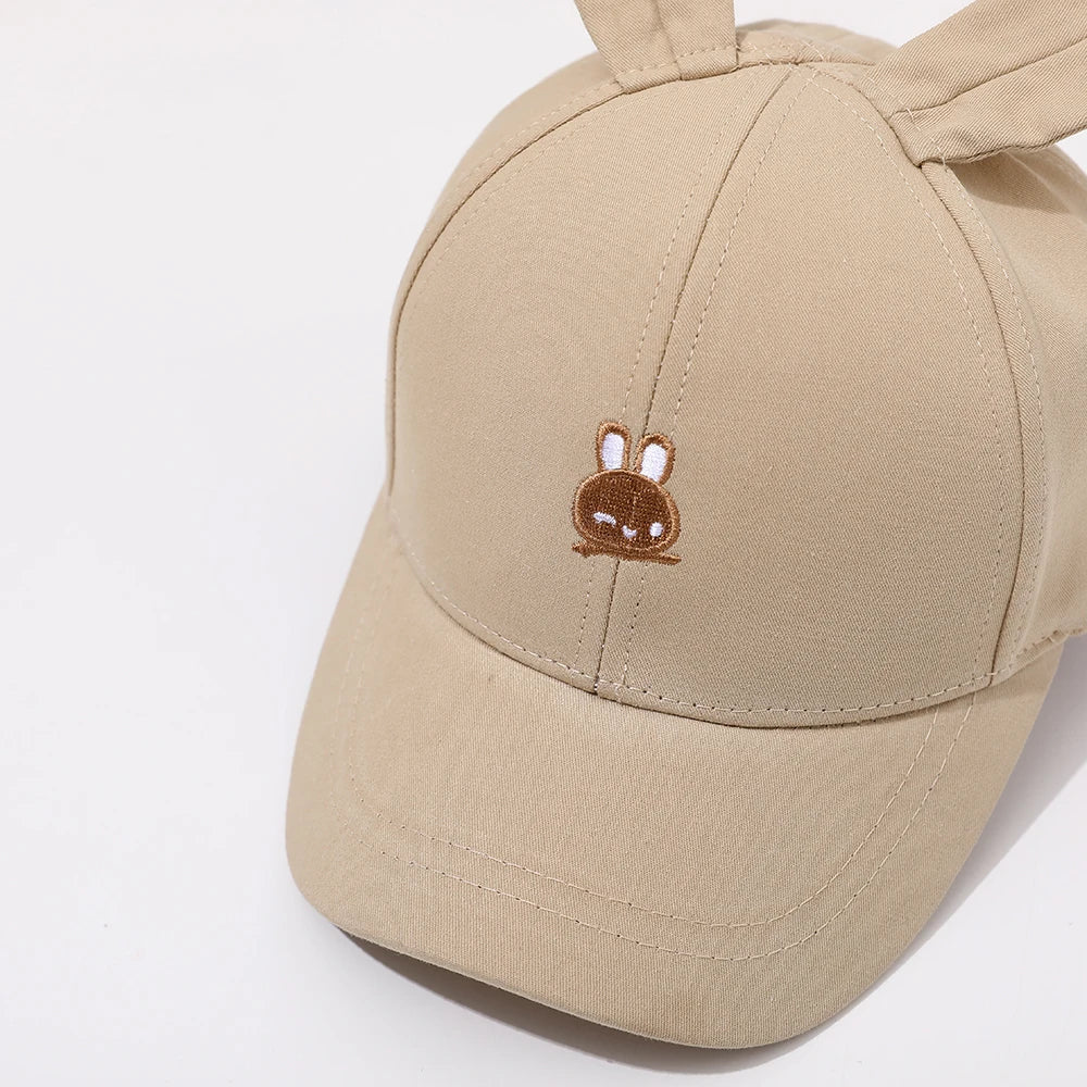 Introducing the adorable Bunny Ears Baseball Hat, available in pink, black, white, and khaki for children newborn to 3 years old! Perfect for adding a touch of cuteness to any outfit.