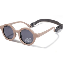 Load image into Gallery viewer, Indulge your little one&#39;s eyes with the ultimate protection and style of these polarized baby and toddler sunglasses! Perfect for ages 0-36 months, these round shades come with a flexible strap for added security and comfort. Whether your child is a newborn or an energetic toddler, these sunglasses are sure to keep their eyes safe and stylish!
