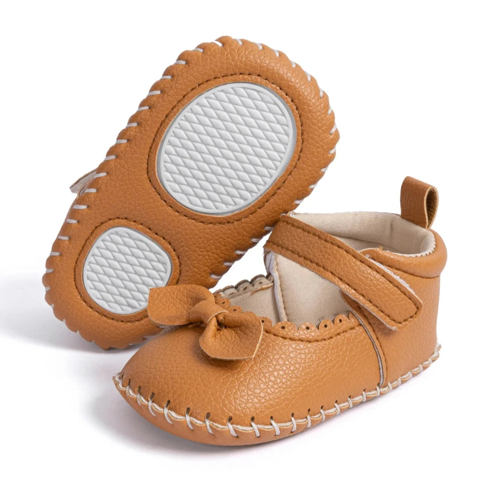 Designed with both style and comfort in mind, these Little Bow-Tie baby shoes are available in a variety of colors and sizes for newborns up to 18 months old. Each pair is meticulously crafted to provide a snug and secure fit for your little princess. Whether you're dressing them up for a special occasion or keeping them comfy for everyday wear, these shoes are the perfect choice for your little one.