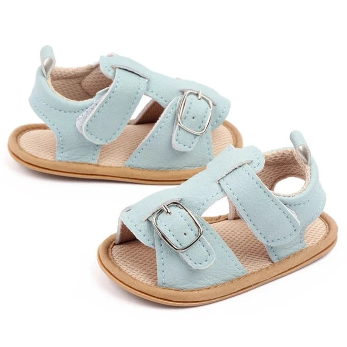 Bring comfort and style to your little one's summer with these adorable sandals in vibrant yellow, crisp white, and cool blue. Perfect for newborns to 18-month-olds, these sandals will have your baby looking cute from every angle. Elevate your baby's style with these adorable and versatile sandals! Keep your little one's feet cool and comfortable all summer long with these must-have sandals