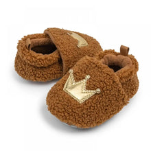 Load image into Gallery viewer, These cozy, snuggly slippers are fit for a royal baby! Made with fluffy teddy bear fabric to keep little toes warm and toasty. Available in sizes for newborns up to 18 months old. Choose from white, grey, or brown.
